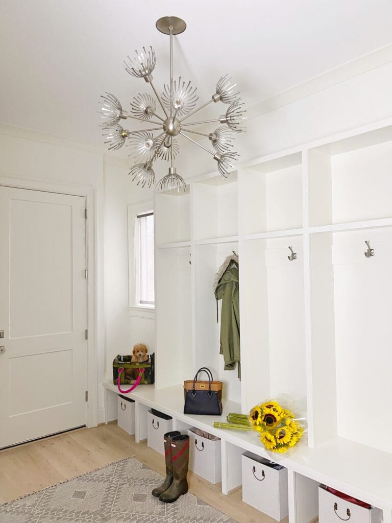 A white room with a bunch of shelves and a large mirror